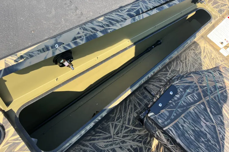 Slide: The Image of 2024 Lowe Outlet 20 boat storage compartment with camouflage design. - 20