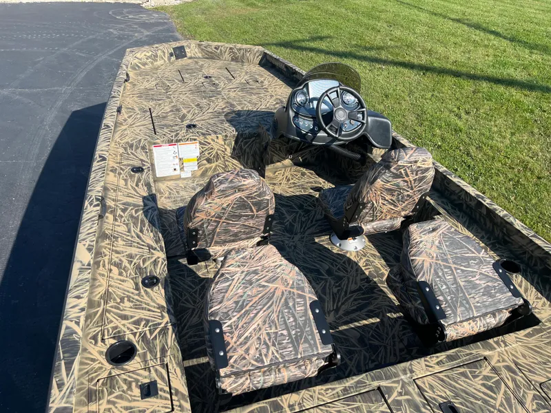 Slide: The Image of 2024 Lowe Outlet 20 boat with camouflage design and steering console. - 5