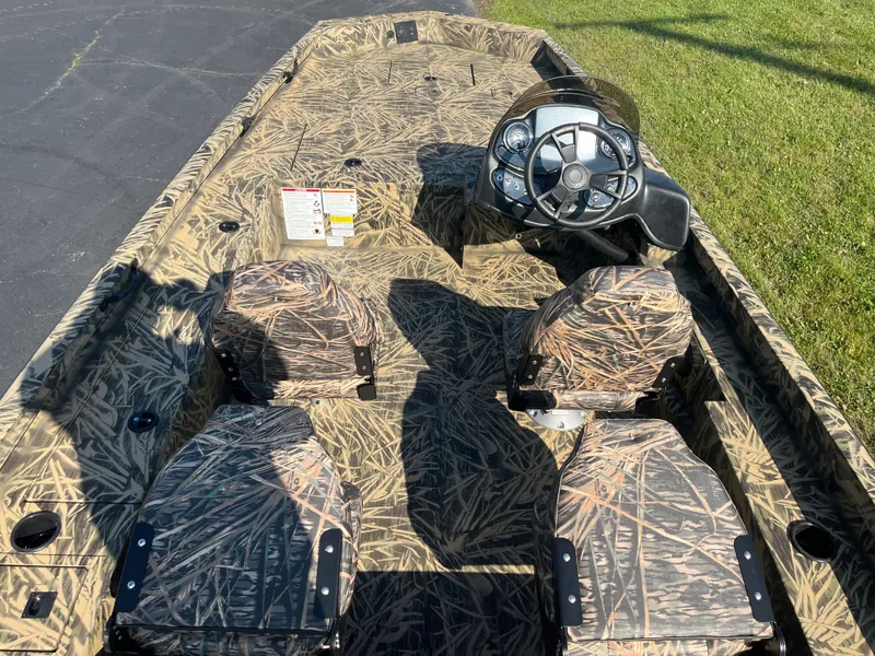 Slide: The Image of 2024 Lowe Outlet 20 boat with camouflage interior and steering console. - 6