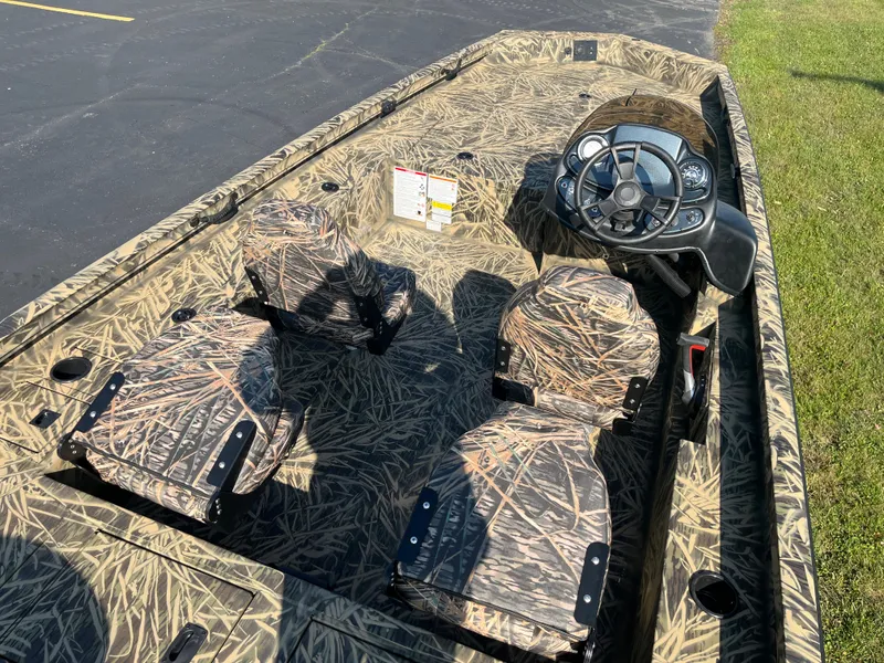 Slide: The Image of 2024 Lowe Outlet 20 boat with camo interior and steering console. - 7