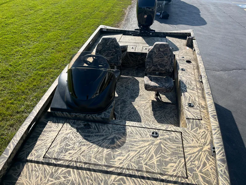 Slide: The Image of 2024 Lowe Outlet 20 boat with camouflage interior and dual seats. - 8