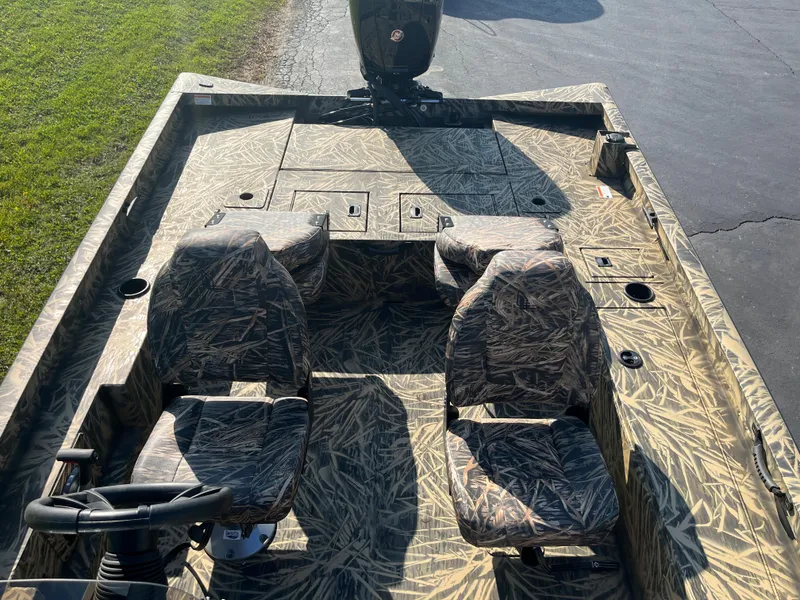 Slide: The Image of 2024 Lowe Outlet 20 boat with camo seats and deck. - 9