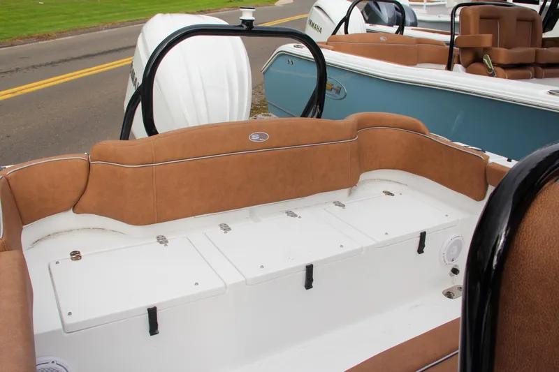 Slide: The Image of 2024 Sea Hunt Ultra 255 SE boat with brown cushioned seating and storage compartments. - 10