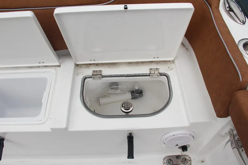 Slide: The Image of Open storage compartments on a 2024 Sea Hunt Ultra 255 SE boat. - 11