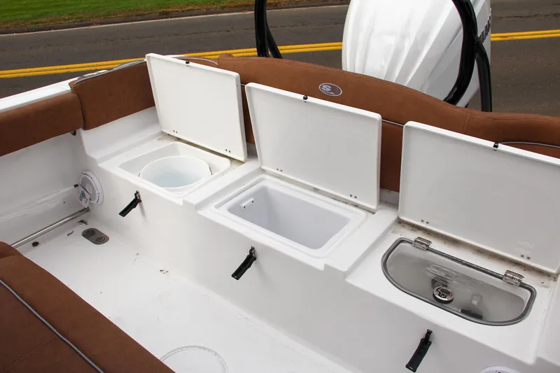 Slide: The Image of 2024 Sea Hunt Ultra 255 SE boat storage compartments and seating area. - 12