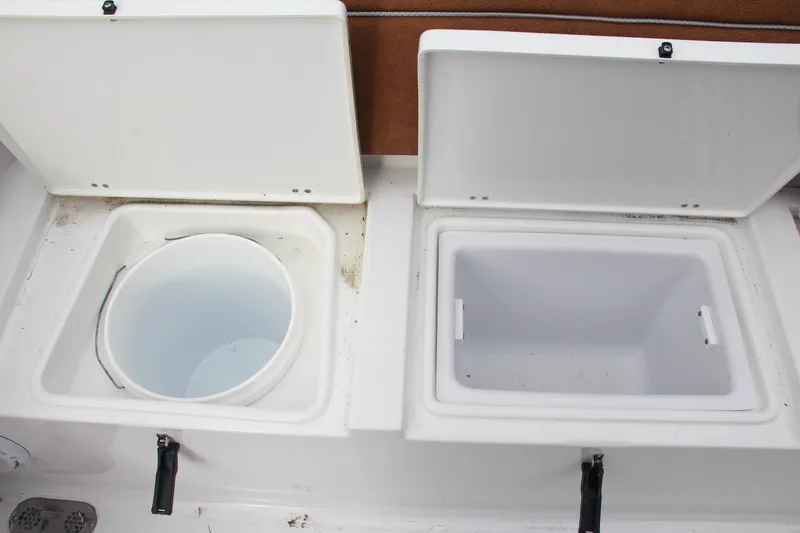 Slide: The Image of Open storage compartments on a 2024 Sea Hunt Ultra 255 SE boat. - 13