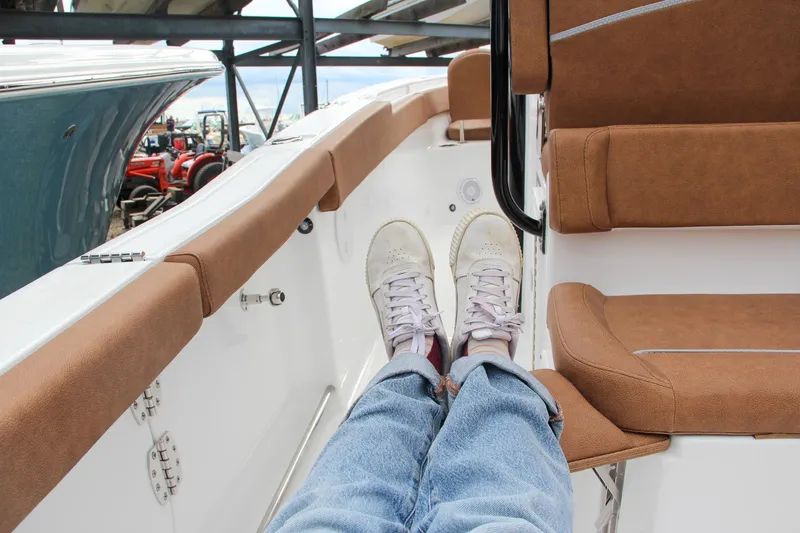 Slide: The Image of 2024 Sea Hunt Ultra 255 SE interior with brown seating and white deck. - 20