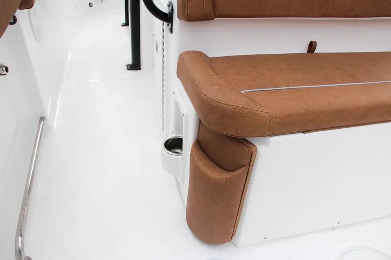 Slide: The Image of 2024 Sea Hunt Ultra 255 SE boat interior with brown cushioned seating. - 21