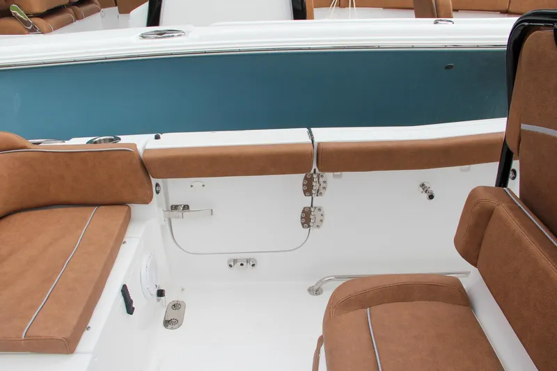 Slide: The Image of 2024 Sea Hunt Ultra 255 SE boat interior with brown cushioned seating. - 22