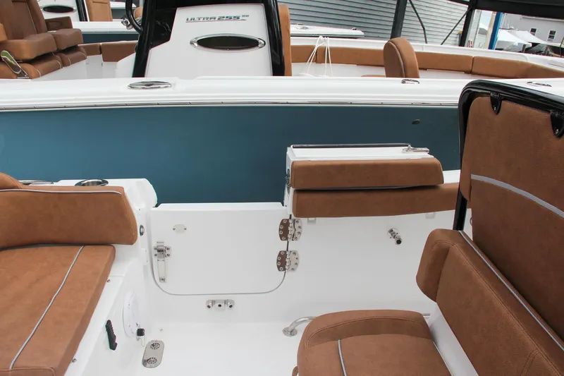Slide: The Image of 2024 Sea Hunt Ultra 255 SE boat interior with brown seating and white deck. - 23