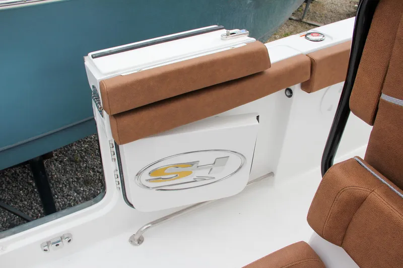 Slide: The Image of 2024 Sea Hunt Ultra 255 SE boat interior with brown cushioned seating. - 25