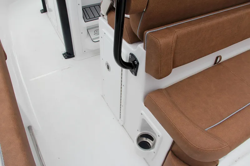 Slide: The Image of 2024 Sea Hunt Ultra 255 SE boat interior with brown seating and white deck. - 26