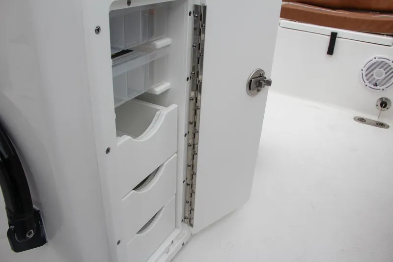 Slide: The Image of Storage compartment with drawers on the 2024 Sea Hunt Ultra 255 SE boat. - 27