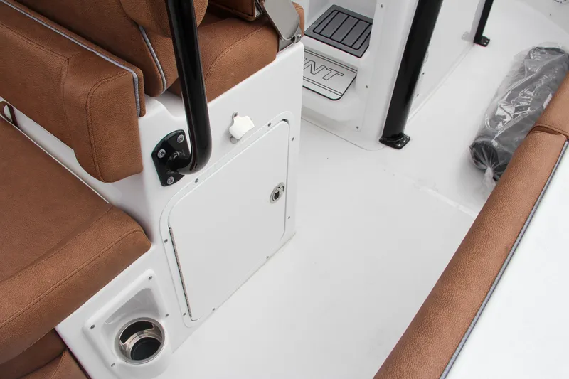 Slide: The Image of 2024 Sea Hunt Ultra 255 SE boat interior with brown seating and storage compartment. - 29