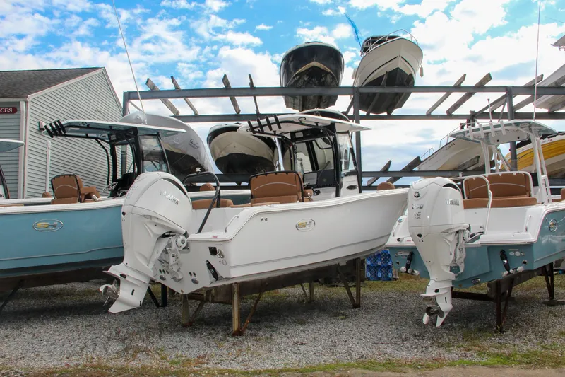 Slide: The Image of 2024 Sea Hunt Ultra 255 SE boats displayed at a marina. - 3