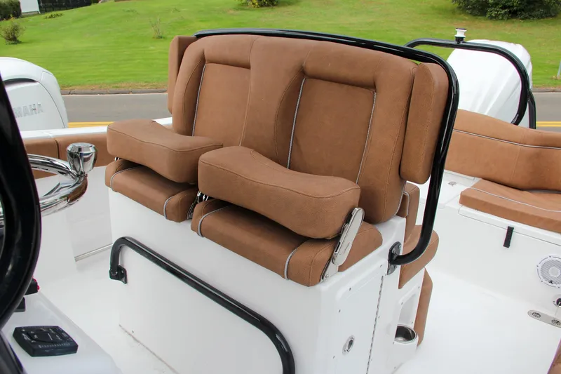 Slide: The Image of 2024 Sea Hunt Ultra 255 SE boat with brown cushioned seating. - 32