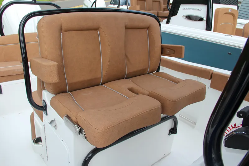 Slide: The Image of 2024 Sea Hunt Ultra 255 SE boat seating with tan cushions. - 33