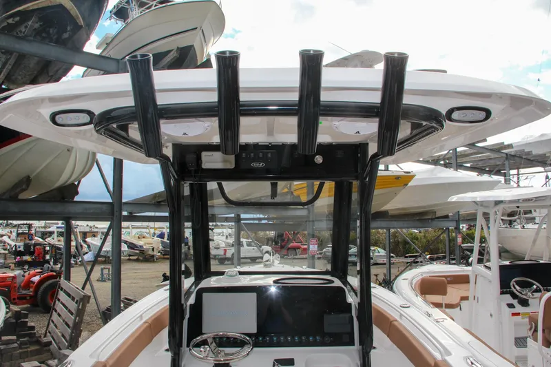 Slide: The Image of 2024 Sea Hunt Ultra 255 SE boat console and helm station in a marina. - 34