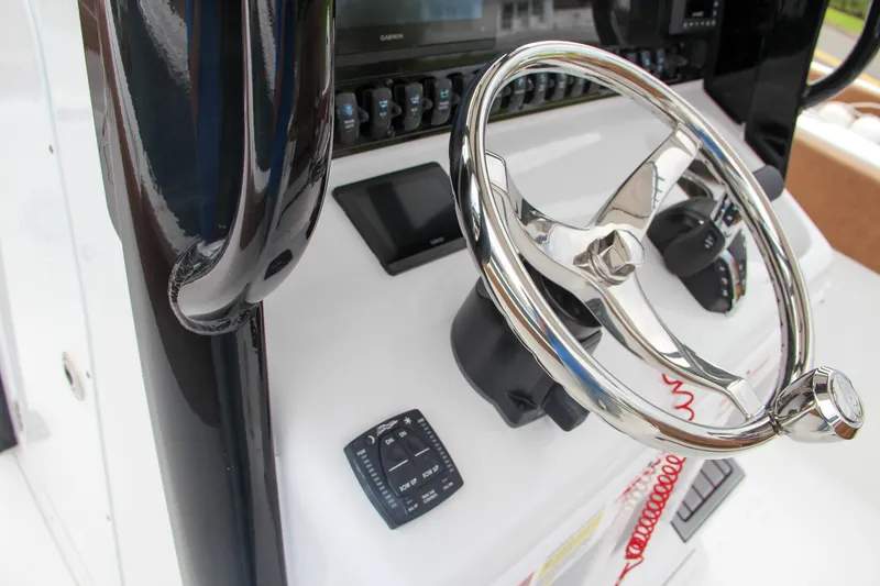 Slide: The Image of Close-up of the 2024 Sea Hunt Ultra 255 SE boat's steering wheel and control panel. - 37