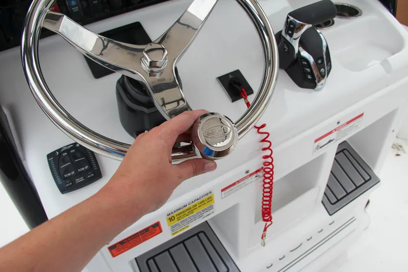 Slide: The Image of 2024 Sea Hunt Ultra 255 SE boat steering wheel and control panel. - 38