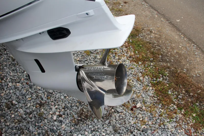 Slide: The Image of 2024 Sea Hunt Ultra 255 SE boat propeller on gravel. - 4