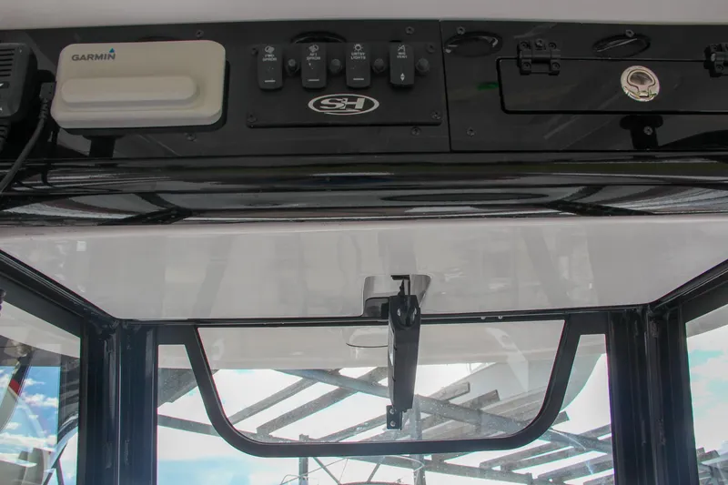 Slide: The Image of 2024 Sea Hunt Ultra 255 SE dashboard with Garmin controls and switches. - 43