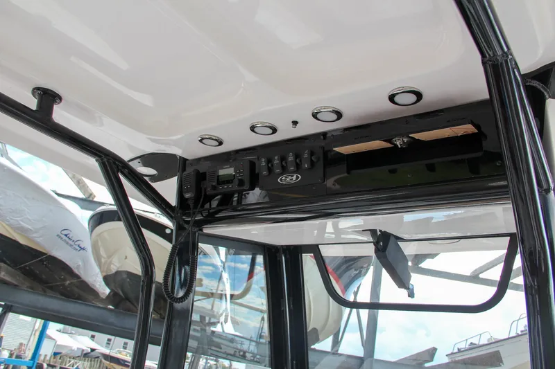 Slide: The Image of 2024 Sea Hunt Ultra 255 SE boat interior console with electronic controls. - 44