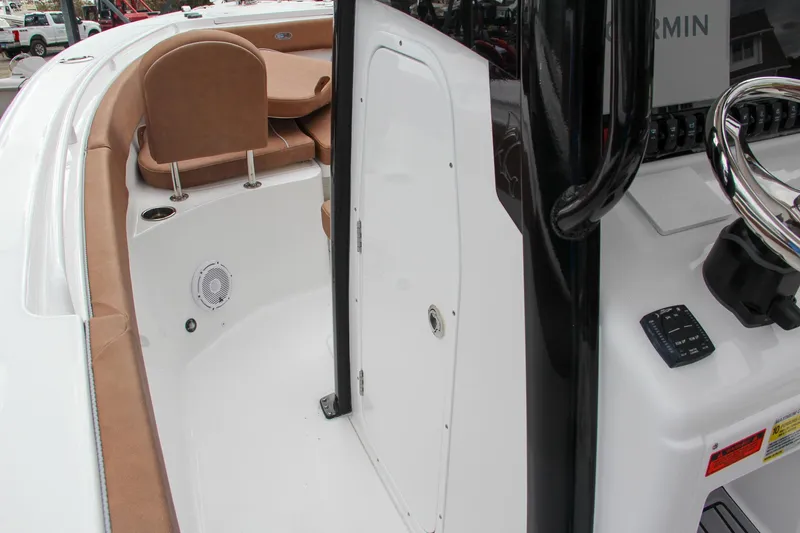 Slide: The Image of 2024 Sea Hunt Ultra 255 SE boat interior with seating and storage compartment. - 46