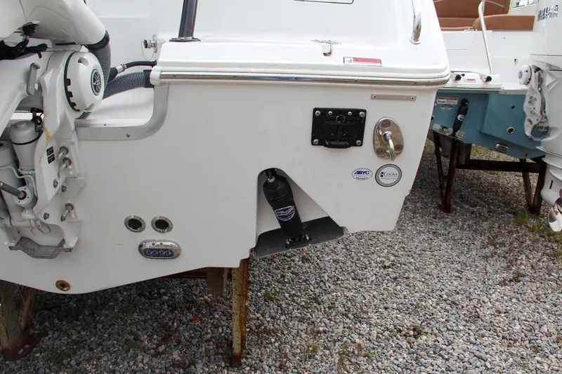 Slide: The Image of 2024 Sea Hunt Ultra 255 SE boat stern on gravel lot. - 5