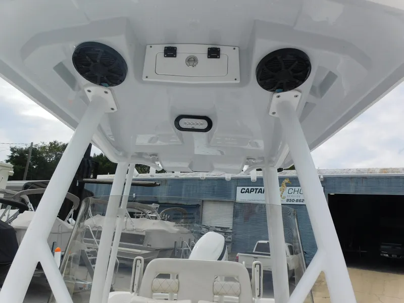 Slide: The Image of 2024 Blue Wave 2600 PureBay boat interior with overhead speakers and seating. - 11