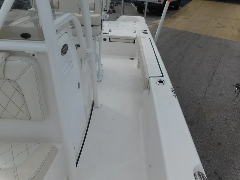 Slide: The Image of 2024 Blue Wave 2600 PureBay boat interior, white seating and deck. - 12