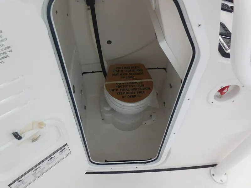 Slide: The Image of 2024 Blue Wave 2600 PureBay boat interior with a marine toilet. - 13