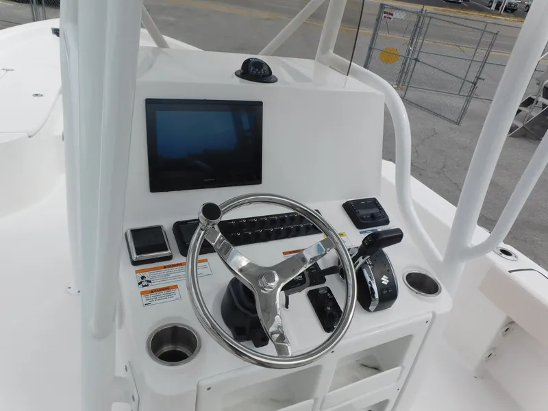 Slide: The Image of 2024 Blue Wave 2600 PureBay boat console with steering wheel and navigation screen. - 14