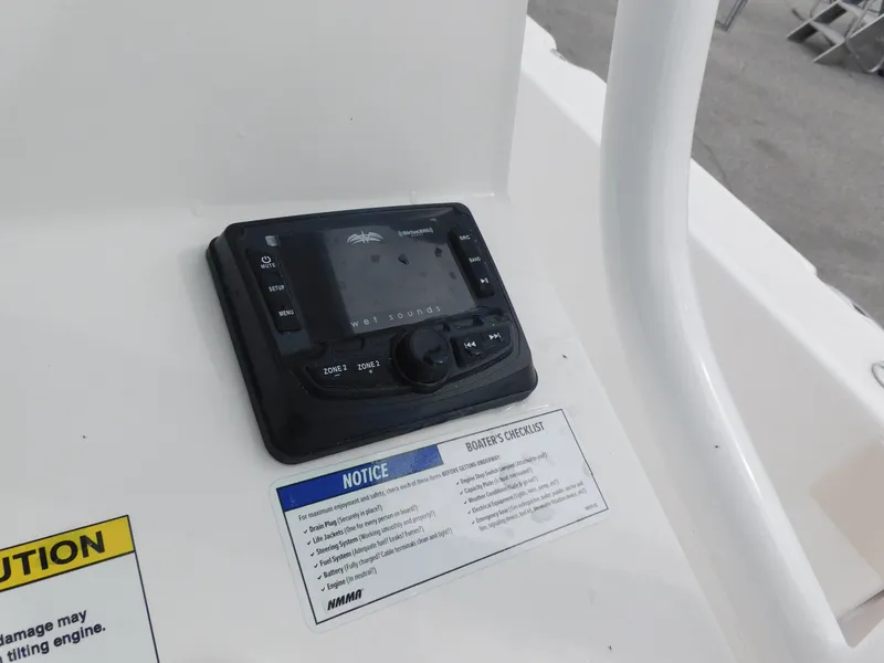 Slide: The Image of Control panel of 2024 Blue Wave 2600 PureBay boat with safety notices. - 17