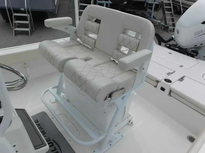 Slide: The Image of 2024 Blue Wave 2600 PureBay boat with dual cushioned seats and armrests. - 19