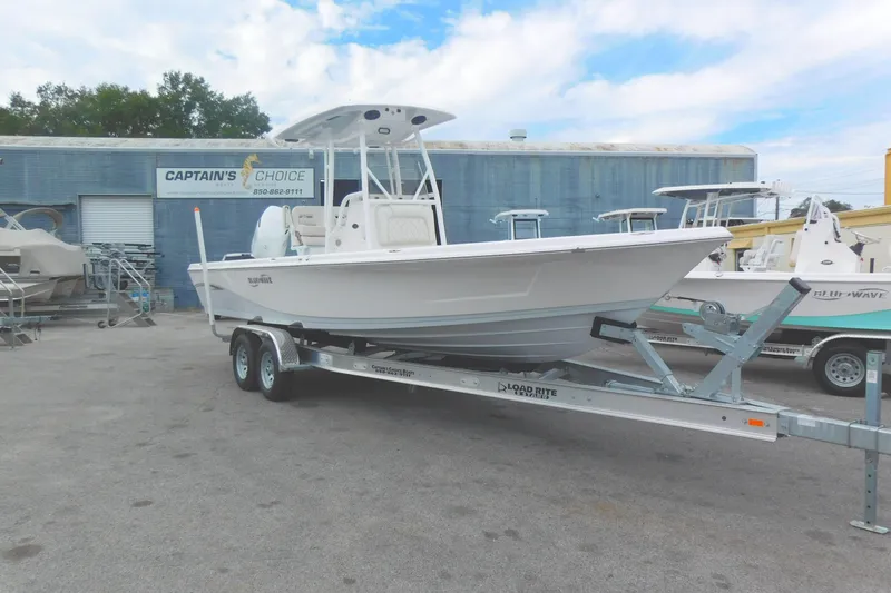 Slide: The Image of 2024 Blue Wave 2600 PureBay boat on trailer at Captain's Choice dealership. - 2