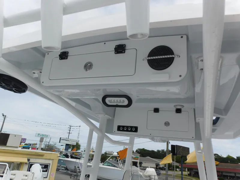 Slide: The Image of 2024 Blue Wave 2600 PureBay boat console with storage compartments and speakers. - 21