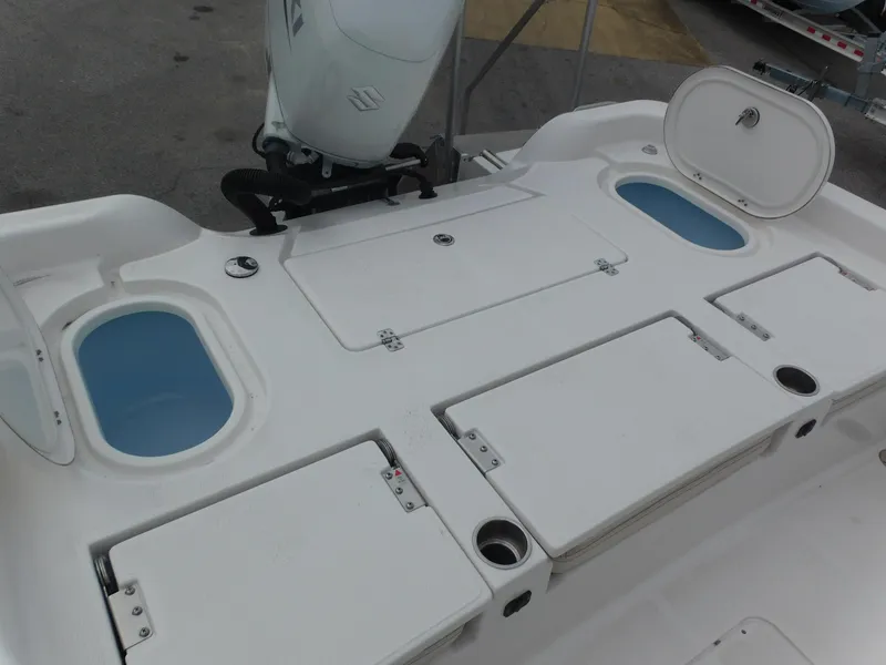 Slide: The Image of 2024 Blue Wave 2600 PureBay boat deck with storage compartments and live wells. - 24