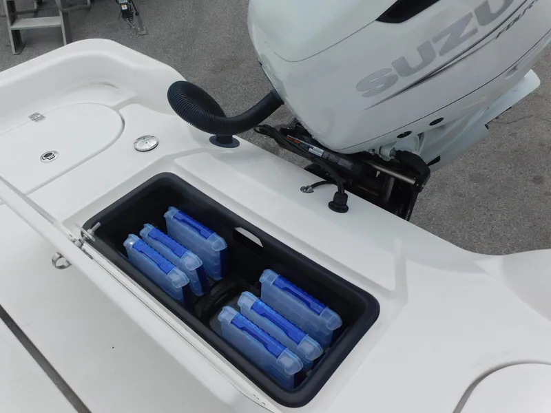 Slide: The Image of 2024 Blue Wave 2600 PureBay boat with Suzuki outboard motor and storage compartment. - 25