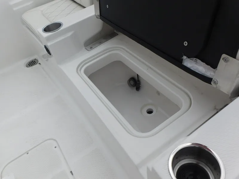 Slide: The Image of 2024 Blue Wave 2600 PureBay boat interior with storage compartment and cup holders. - 27