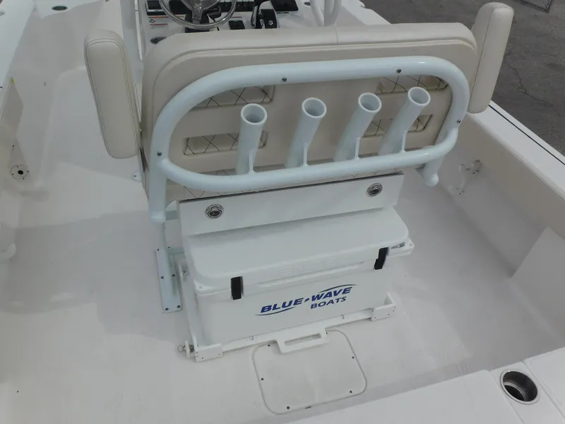 Slide: The Image of 2024 Blue Wave 2600 PureBay boat with rod holders and storage compartment. - 29