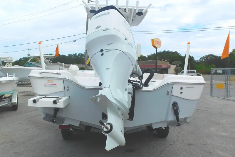 Slide: The Image of 2024 Blue Wave 2600 PureBay boat rear view with outboard motor. - 4