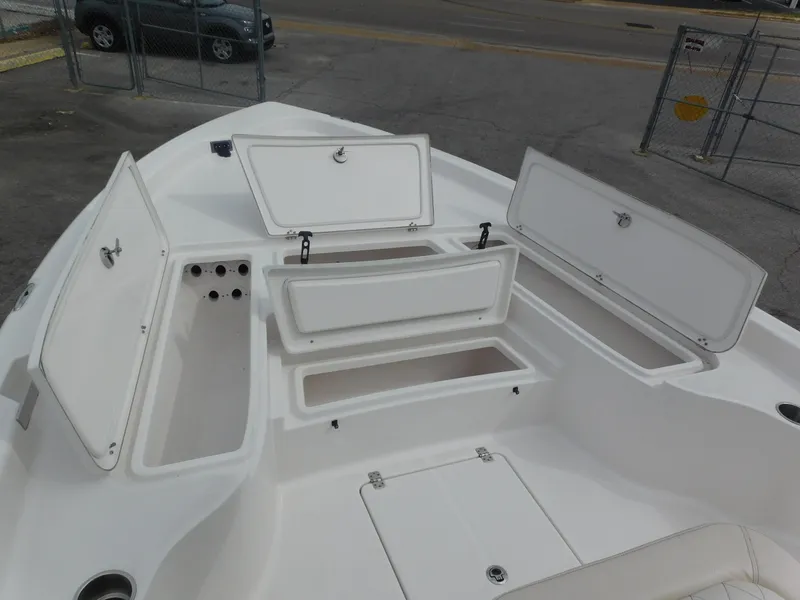 Slide: The Image of 2024 Blue Wave 2600 PureBay boat with open storage compartments. - 7