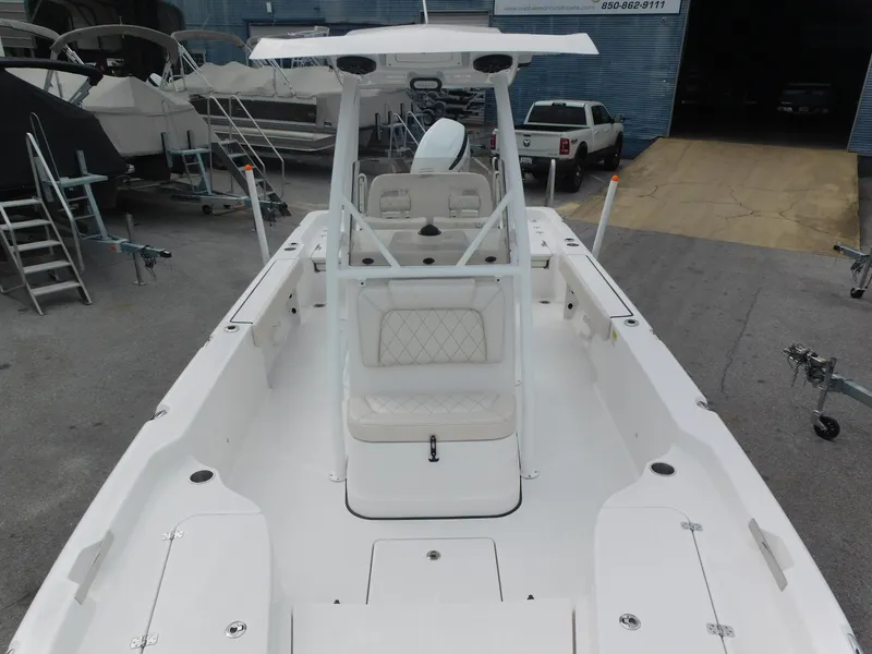 Slide: The Image of 2024 Blue Wave 2600 PureBay boat interior, white seating, and center console. - 9