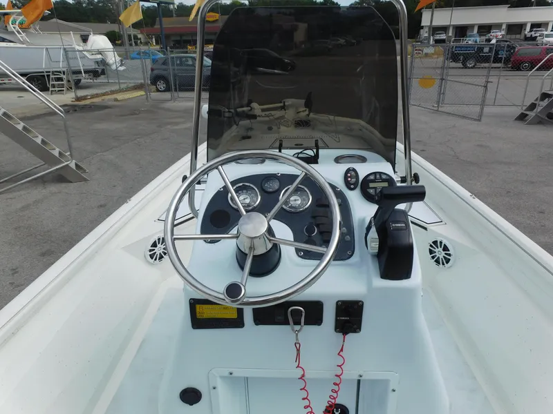 Slide: The Image of 2018 Excel 22'3 Bay Pro boat console with steering wheel and controls. - 13