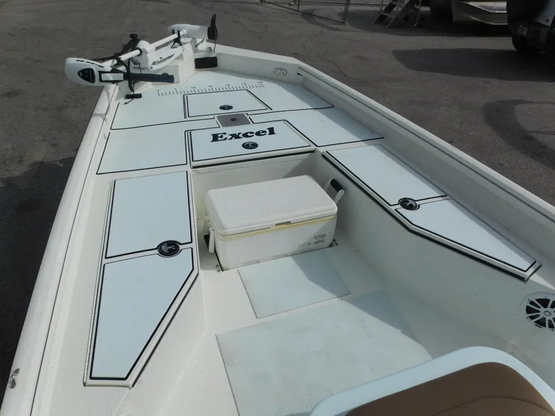 Slide: The Image of 2018 Excel 22'3 Bay Pro boat deck with storage compartments and cooler. - 7