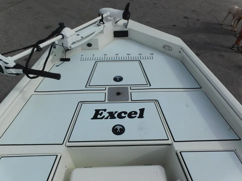 Slide: The Image of 2018 Excel 22'3 Bay Pro boat deck with storage compartments and trolling motor. - 8