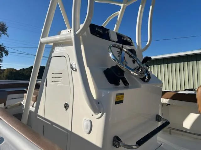 Slide: The Image of 2024 Pioneer 222 Islander boat console and steering wheel. - 2