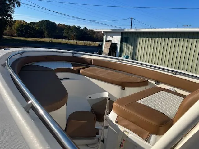 Slide: The Image of 2024 Pioneer 222 Islander boat interior with brown and white seating. - 3