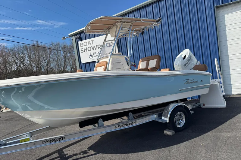 Slide: The Image of 2026 Pioneer 202 Sportfish boat on trailer outside showroom. - 11